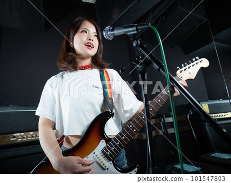 Woman playing guitar Woman playing guitar 101547893