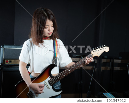 Woman playing guitar Woman playing guitar 101547912