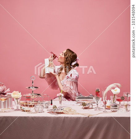 Shot of hungry adorable queen wearing baroque dress and eating with chinese chopsticks near festive laid table. Asian cuisine 101548094