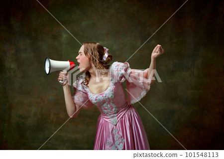 One charming blond princess wearing fancy pink dress screaming through megaphone over vintage texture background. Attention, please 101548113