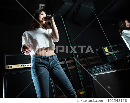 Young woman photographing in recording studio Young woman photographing in recording studio 101548158