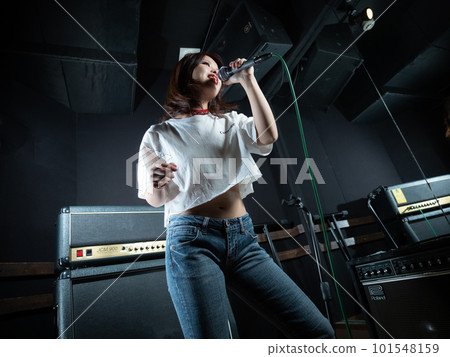 Young woman photographing in recording studio Young woman photographing in recording studio 101548159