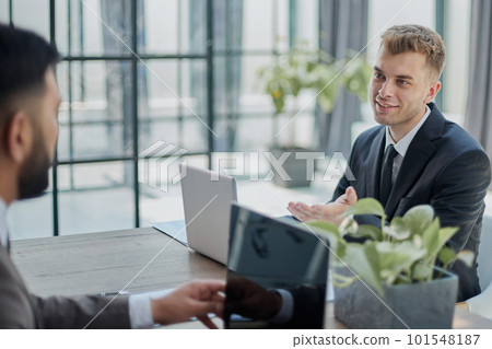 Two happy men working together on a new business project Two happy men working together on a new business project 101548187