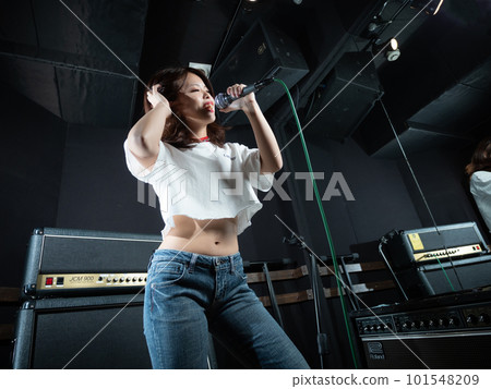 Young woman photographing in recording studio Young woman photographing in recording studio 101548209