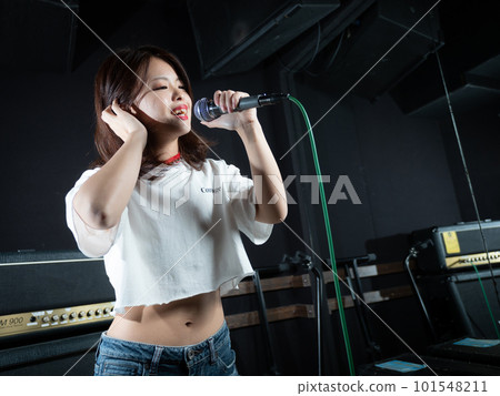 Young woman photographing in recording studio Young woman photographing in recording studio 101548211