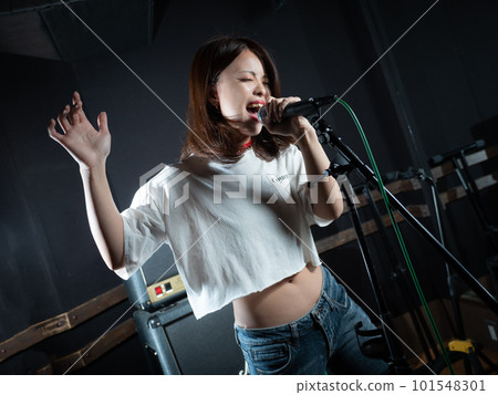 Young woman photographing in recording studio Young woman photographing in recording studio 101548301