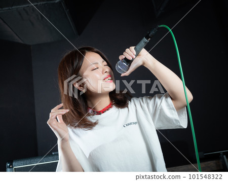 Young woman photographing in recording studio Young woman photographing in recording studio 101548322