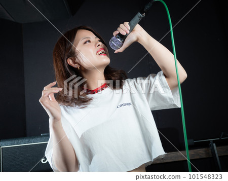 Young woman photographing in recording studio Young woman photographing in recording studio 101548323