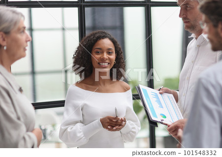 Negotiations in the office. A young woman talks with colleagues 101548332