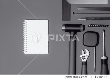Flat lay composition with set of home repair tools and opened notebook on grey background. Top view pattern with copy space. 101548515