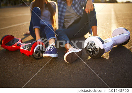 Young man and woman riding on the Hoverboard in the park. content technologies. a new movement. 101548700