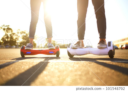 Young man and woman riding on the Hoverboard in the park. content technologies. a new movement. 101548702