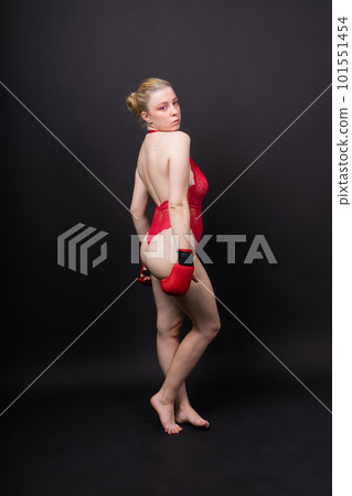 Seductive young and fit female fighter posing in gloves in studio Seductive young and fit female fighter posing in gloves in studio 101551454