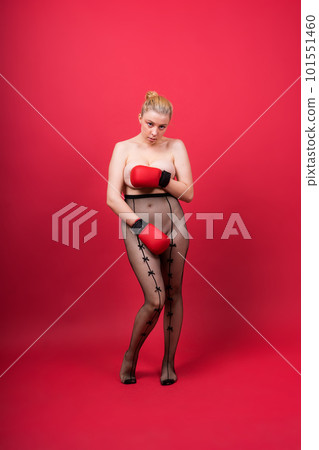 Seductive young and fit female fighter posing in gloves in studio Seductive young and fit female fighter posing in gloves in studio 101551460