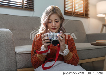 Portrait of pretty young woman looking at pictures from the camera Portrait of pretty young woman looking at pictures from the camera 101552281