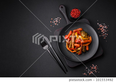 Mix of vegetables corn, carrots, peppers, broccoli, onions in teriyaki sauce 101553492