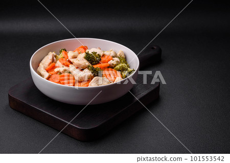 Delicious dish consisting of pieces of boiled chicken, broccoli and carrots 101553542