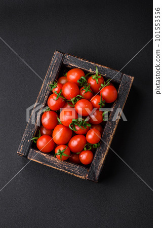 Fresh red cherry tomatoes in a wooden vintage box Fresh red cherry tomatoes in a wooden vintage box 101553556