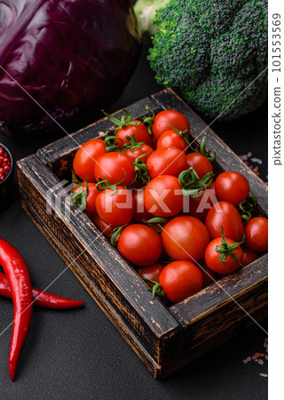 Fresh red cherry tomatoes in a wooden vintage box Fresh red cherry tomatoes in a wooden vintage box 101553569