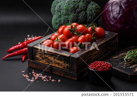 Fresh red cherry tomatoes in a wooden vintage box 101553571