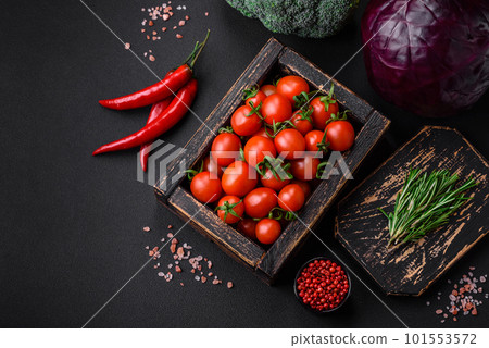 Fresh red cherry tomatoes in a wooden vintage box Fresh red cherry tomatoes in a wooden vintage box 101553572