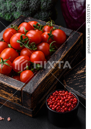 Fresh red cherry tomatoes in a wooden vintage box Fresh red cherry tomatoes in a wooden vintage box 101553574