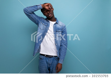 sad african man with dreadlocks in a denim jacket 101553703