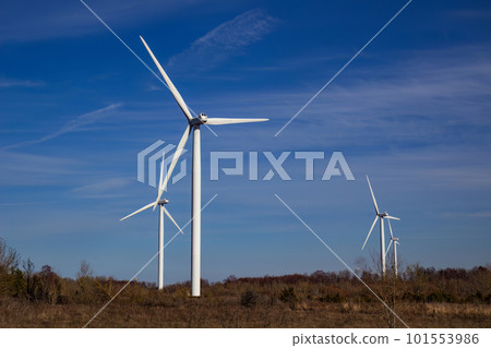Wind turbines against blue sky background. 101553986