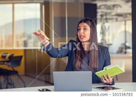 Photo of pretty young girl sit desktop pc hold pen write notepad shirt in home office indoors. 101556783