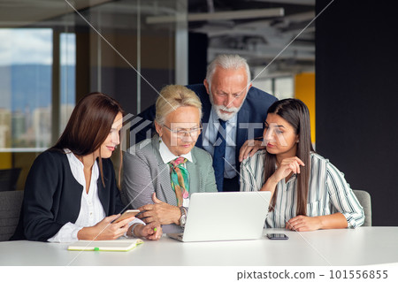 Mature businessman leader mentor talking to diverse colleagues team listening to caucasian ceo. Mature businessman leader mentor talking to diverse colleagues team listening to caucasian ceo. 101556855
