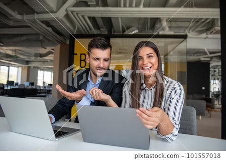 Young latin couple working using laptop sitting on the table at home. Young latin couple working using laptop sitting on the table at home. 101557018