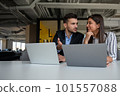 Young latin couple working using laptop sitting on the table at home. 101557088