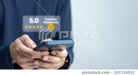 Customer service satisfaction evaluation concept. Man using smartphone and touching on screen with gold five star rating excellent feedback icon, Rated a very good review. Customer service satisfaction evaluation concept. Man using smartphone and touching on screen with gold five star rating excellent feedback icon, Rated a very good review. 101558932