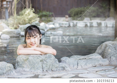 A young woman taking a leisurely open-air bath A young woman taking a leisurely open-air bath 101559213