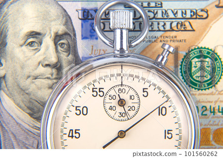 mechanical stopwatch on the background of dollars mechanical stopwatch on the background of dollars 101560262