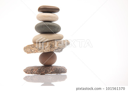 pyramid of stacked stones on a white background. stabilization and balance in life 101561370