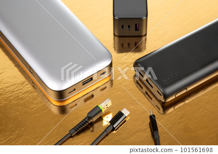 Powerbank portable on a golden background. Electronic devices for charging gadgets and smartphones 101561698