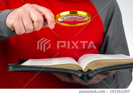 Magnifying glass for reading a book. Open bible. The study of literature. 101562047