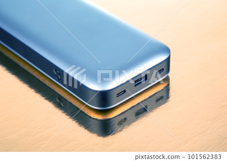Powerbank portable on a golden background. Electronic devices for charging gadgets and smartphones Powerbank portable on a golden background. Electronic devices for charging gadgets and smartphones 101562383