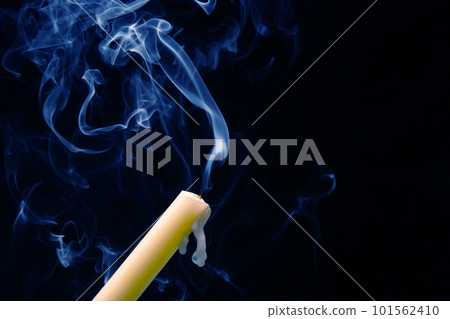 Smoke from an extinguished candle on a dark background. Smoke from an extinguished candle on a dark background. 101562410