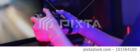 Hand of female cyber hacker gamer holding controller joystick to playing games on computer 101564100