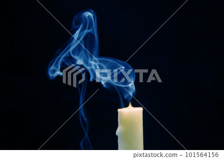 Smoke from an extinguished candle on a dark background. Smoke from an extinguished candle on a dark background. 101564156