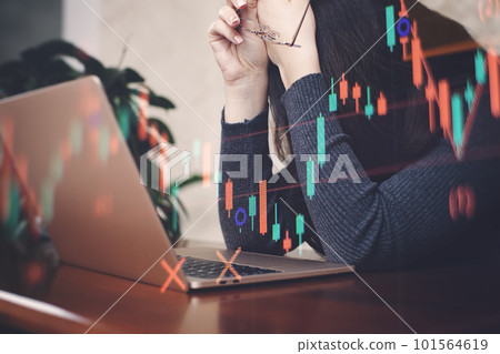 Businesswoman working with laptop on wooden desk, stock market chart. 101564619