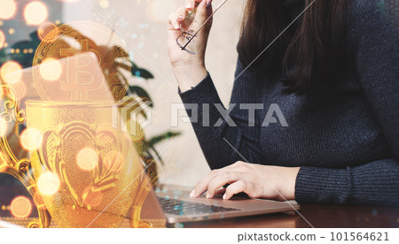 Woman using laptop with bitcoin hologram. Cryptocurrency concept. Double exposure. 101564621