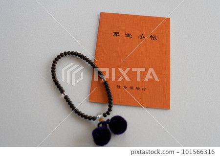 Pension book and prayer beads 101566316
