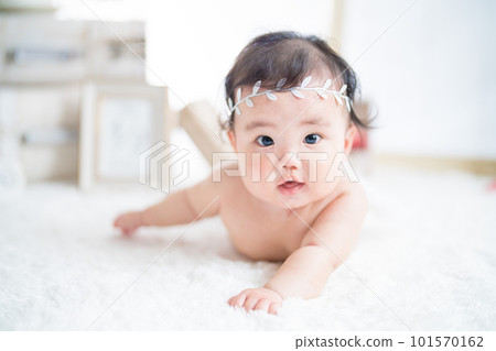 6 month old angel baby celebrating half birthday with bright natural light 101570162