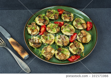Baked zucchini with mushrooms 101571066