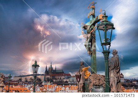 Crucifix on pedestrians only Charles Bridge over Vltava river in Prague, Czech Republic during thunderstorm and lightening. 101571473