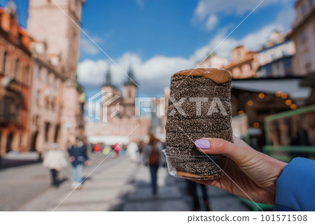 Traditional Tasty Baked Trdelnik in Czech Republic, Tyn Church on the Background 101571508