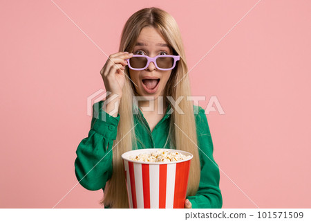 Woman in 3D glasses eating popcorn and watching interesting tv serial, sport game film online movie 101571509